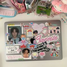 a laptop covered in lots of stickers and magnets