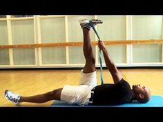 a man is doing an exercise on a blue mat