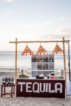 a bar set up on the beach for tequila