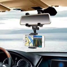 a car mirror mounted to the side of a dashboard with a cell phone in it