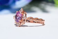 Natural Amethyst Ring, Vintage Inspired and paired with a V Shaped band, made of 10k Gold with the color of your choice Main Ring Gemtype: Natural Amethyst Main stone size: 4x6mm side Stone: D color Moissanite Metal Type: 10k Gold , color of your choice Metal Stamp: 10k Stone Origin: Brazil V shaped Band Metal Type: 10k Gold Stone: Moissanite Stone color: D Packaged in a gift ready box. Perfection takes time, please allow 2-3 weeks production time. thanks IMPORTANT: Sizes Fit True, please always Heirloom Purple Ring For Wedding, Heirloom Purple Rings For Weddings, Heirloom Purple Wedding Rings, Heirloom Purple Sapphire Ring For Anniversary, Purple Diamond Ring With Halo Setting For Anniversary, Lavender Wedding Ring With Center Stone, Heirloom Purple Diamond Wedding Ring, Heirloom Style Purple Diamond Wedding Ring, Purple Crystal Ring With Halo Setting For Anniversary