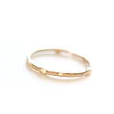 Introducing the original Dainty Ring - a must-have for every ring stack! Made from 14k yellow gold, this ring is both delicate and chic. Wear it alone for a minimalist look or stack it up to create a personalized set. Handcrafted with care, each ring is unique, showcasing its own rustic character. Measuring 1mm in width, this ring is the perfect addition to your jewelry collection. • Please note that Amy will need two weeks to create your ring with utmost attention to detail. Classic Everyday Stackable Toe Rings, Everyday Stackable Open Band Rings With Simple Design, Timeless Adjustable Stackable Rings For Everyday, Dainty 14k Gold Stackable Rings, Simple Stackable Open Band Rings, Simple Everyday Jewelry With Smooth Bezel, Delicate Everyday Stackable Round Band Rings, Dainty 14k Gold Stackable Rings With Open Band, Simple Open Band Stackable Jewelry