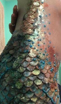 the back of a woman's body is covered in sequins and beads