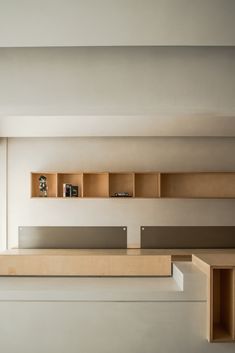 an empty room with wooden shelves on the wall