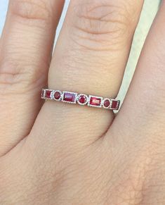 Vintage Ruby Baguette and Round Art Deco HALF Eternity Band. Material: Solid Gold (14K or 18K) or PLATINUM Finishing: High Polished/ Shiny Plating: Rhodium/ Platinum Family (if White Gold) Detail: Milgrain Fit: Standard Band Width: 3 mm on top (2mm on bottom) Band Height: 3 mm on top (1.8mm on bottom) Setting Type: Bezel Stone: Natural Ruby Stone Measurements: Baguette - 2x3mm, Round - 2mm This alternating circle-baguette design will compliment any style engagement ring and will be a stand out w Anniversary Ruby Jewelry With Baguette Diamonds, Anniversary Jewelry With Baguette Diamonds And Ruby, Ruby Jewelry With Baguette Diamonds For Anniversary, Elegant Ruby Ring With Baguette Diamonds, Red Baguette Diamond Wedding Rings, Elegant Wedding Ruby Ring Hand Set, Red Baguette Cut Diamond Jewelry, Elegant Hand-set Ruby Ring For Wedding, Red Baguette Cut Jewelry With Baguette Diamonds