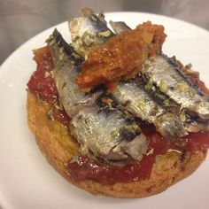 some kind of food that is on top of a white plate and sitting on a table