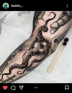 a person with a tattoo on their arm and an eye in the middle of it