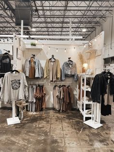 the inside of a clothing store with clothes on display