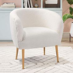 a white chair sitting on top of a rug