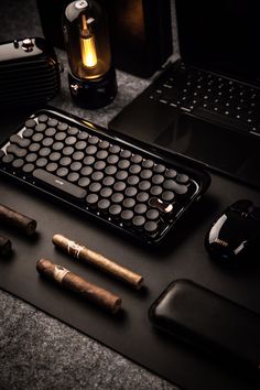 an assortment of cigars and electronic devices on a table