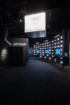 an empty room with lights on the walls and black curtains in front of it that says ripugo