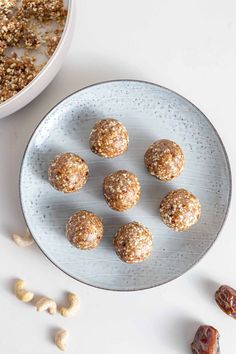 a plate full of nuts next to a bowl filled with oatmeal balls