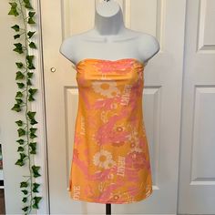 Orange And Pink Strapless Dress With A Floral Pattern #90s Princess Polly Paradise City Mini Dress Nwt Never Worn Y2k Mini Dress For Vacation, Retro Pink Mini Dress For Beach, Strapless Orange Mini Dress For Spring, Spring Beach Y2k Style Dresses, Y2k Style Beach Dresses For Spring, Y2k Style Mini Beach Dress, Y2k Mini Beach Dress, Flirty Pink Strapless Dress For Summer, Summer Pink Strapless Mini Dress