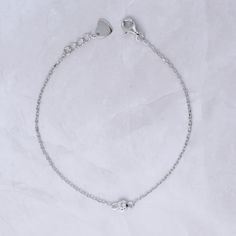 This super cute bezel bracelet is great for layering or wearing on its own! Delicate & dainty - this is perfect for a minimalist look. 14K Gold Plated on Sterling Silver Highest grade CZ for an authentic look! Bezel size: 4mm Includes .5" extension Lobster clasp closure Delicate Sterling Silver Round Chain Bracelet, Delicate Sterling Silver Chain Bracelet, Dainty Bezel Set Chain Bracelet, Classic Silver Bracelet With Delicate Chain, Classic Silver Bracelets With Delicate Chain, Everyday Silver Tarnish Resistant Diamond Bracelet, Dainty Hypoallergenic White Gold Charm Bracelet, Silver Dainty Bracelet With Extender, Minimalist Sterling Silver Diamond Bracelet With Jubilee Design