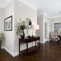 a living room with hard wood floors and white walls