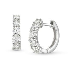 Perfect your everyday look with the modern and sophisticated design of these certified diamond huggie hoop earrings in white gold. Crafted in 14K white gold Each hoop showcases certified diamonds - boasting a color rank of H and clarity of I1 - subtly graduating to the largest 1/8 ct. stones at the bottom. Captivating with 1 ct. t.w. of diamonds Includes certification card These earrings secure with hinged backs. Huggie Hoop Earrings, Sophisticated Design, Everyday Look, The Modern, Hoop Earrings, Diamonds, White Gold, Stone, Gold