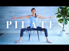 a woman sitting on top of a chair in front of a plant