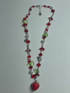 Adorable necklace made with various elements that pull together to make a cohesive design of dripping in strawberries and flowers. The red and white beads shine in the light while the rounds represent budding strawberries. Perfect for any garden fairy or someone who needs a perfect addition to any picnic outfit! this necklace is sure to turn heads and give you the confidence to stand tall.  Necklace is 26 cm with and adjustable chain up to 30 cm gaurenteing a perfect fit for everyone! Also feauting a small spiralat the end to add a cute touch to the back of the necklace.  Each item comes with an assortment of freebies that could incldue stickers, crystals, shells, enamel pins, bookmarks, and more! Picknick Outfit, Spring Red Jewelry With Flower Charm, Elegant Red Flower Necklace With Charm, Picknick Outfits, Adjustable Red Flower Necklace, Red Flower-shaped Beaded Necklace For Gift, Strawberry Pearl Necklace, Strawberries And Flowers, Necklace Fairycore