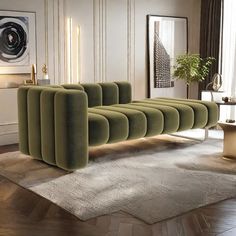 a green couch sitting on top of a wooden floor