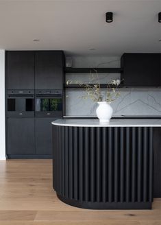 a white vase sitting on top of a counter in a kitchen