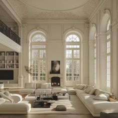 an elegant living room with white furniture and large arched windows, is pictured in this image