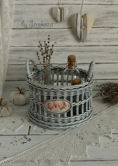 there is a basket with bottles in it on the table next to pumpkins and other decorations