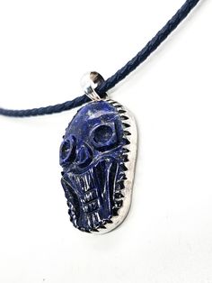 Lapis Lazuli hand carved skull pendant sterling silver custom corded chain. Good vintage condition with little signs of normal wear. Custom braided corded chain with sterling silver capped clasp. Clasp opens with push button on the side. Pendant is set in sterling silver with large saw tooth bezel. Pendant stamped on the back 925. Acid tests positive for sterling silver. Necklace measures 18 inches long. Pendant measures 2 inches long and 1 inch wide. Adjustable Carved Sterling Silver Jewelry, Artisan Carved Adjustable Jewelry, Bohemian Sterling Silver Skull Jewelry, Carved Pendant Jewelry, Artisan Silver Jewelry With Adjustable Cord, Adjustable Carved Pendant Jewelry, Carved Skull, Saw Tooth, Silver Caps