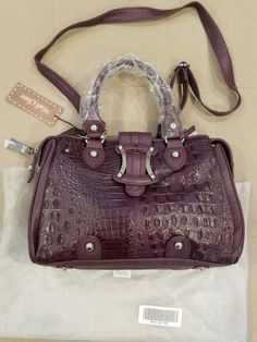 Madi Claire Purple Genuine Leather Croc Embossed Satchel Shoulder Bag NEW. Weight 1lb 13oz. Condition is New with tags. Shipped with USPS Priority Mail. Purple Top Handle Satchel With Adjustable Strap, Purple Leather Satchel With Handles, Purple Leather Satchel With Detachable Strap, Purple Crossbody Satchel With Top Carry Handle, Purple Leather Shoulder Bag With Top Carry Handle, Purple Leather Satchel With Top Carry Handle, Medium Sized Bags, Classic Bags, Purple Lace