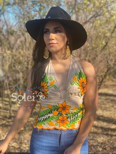 This Beautiful Sunflower Embroidered Halter Top is the perfect Top for Everyday use or a special event. It is comfortable, with elastic on the back and has a tie around the neck for an adjustable fit. This blouse comes in one size which fits sizes Small and Medium. Fitted Floral Embroidered Top For Summer, Fitted Floral Embroidered Top For Festival, Fitted Floral Print Embroidered Top For Summer, Fitted Floral Print Top For Festivals, Summer Embroidered Fitted Blouse, Fitted Multicolor Embroidered Blouse For Summer, Traditional Fitted Embroidered Summer Top, Fitted Traditional Embroidered Top For Summer, Mexican Top