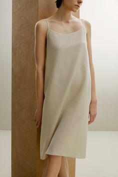 New from our 2022 Spring & Summer Collection, the Silk Cotton Slip Pajama Dress blends elegance and comfort for every evening this summer with a combination of fine silk and skin-friendly cotton — absolutely breathable and effortless to wear, with exquisitely refined design and details that allow you to move to your own rhythm and free your mind. Details Materials & Care Shipping & Returns • Designed in a subtle A-shape: a natural fit with a feminine touch. • Perfectly blends crisp, breathable c Beige Midi Dress For Summer Loungewear, Elegant Relaxed Fit Dress For Loungewear, Neutral Cotton Dress For Daywear, Elegant Cotton Maxi Dress With Straight Neckline, Beige Slip Dress For Summer Sleep, Elegant Unlined Relaxed Fit Dresses, Elegant Relaxed Fit Unlined Dresses, Elegant Relaxed Fit Dress, Beige Slip Dress For Daywear