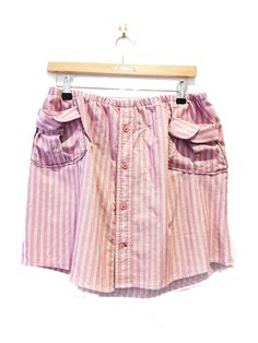 "UPCYCLING... How CUTE is this Pink Pin Stripe cotton skirt. Upcycled entirely from a Men's shirt. With a button down front, \"Cuff\" Pockets and an elasticated waistband.  DETAILS: Upcycled Made from a Men's shirt  Elasticated waistband  Button Down front  Plain Hem  Pockets  FABRIC:  100% Cotton  MEASUREMENTS:  Size : 12 - 14 Waist : 80 - 108cm Down centre front: 42cm FOR UPDATES:  WEBSITE: www.thepinkflamingodesigns.co.uk INSTAGRAM: ThePinkFlamingoDesigns TWITTER : @NatashaLomas2 FACEBOOK: @T Upcycle Clothes Diy, Pink Pin, Clothes Diy, Pin Stripe, Stripe Shirt, Cotton Skirt, Shirt Skirt, Striped Blouse, Upcycle Clothes