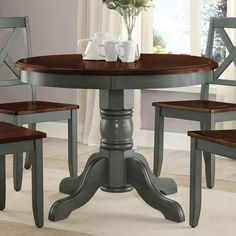 a dining room table with four chairs around it