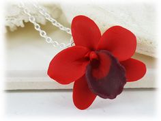 Petite hand sculpted (2.5cm) 1 inch red orchid necklace. The handcrafted orchid pendant drops from on a hand wired bail. Available on silver gold or antique brass styles. -Original hand sculpted polymer clay flowers -Durable, water-resistant -No molds, no paint, no glue -Flower size : 2.5cm Flower (about 1 inch, size of a quarter) -Chain Length : Select 16 inch or 18 inch cable chain -Style : Select Silver-plated, Gold-plated, Antique Brass, 925 sterling Silver or 14k Gold Filled View matching c Unique Orchid-colored Jewelry As A Gift, Unique Orchid Colored Jewelry For Gift, Unique Orchid-colored Jewelry Gift, Unique Orchid Jewelry For Gift, Orchid Flower Pendant Jewelry Gift, Orchid Flower Pendant Jewelry For Gift, Unique Red Flower Jewelry, Unique Red Flower-shaped Jewelry, Unique Red Flower Shaped Jewelry