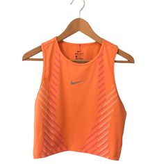 Womens Nike Crop Top Tank Size Large Orange With Pink And White Lines New With Tags 80% Polyester 20% Spandex Nike Logo On Front Is Reflective Orange Sleeveless Top For Athleisure, Orange Sleeveless Athleisure Top, Fitted Orange Gym Tops, Fitted Orange Top For Gym, Sleeveless Orange Sports Top, Nike Stretch Sports Crop Top, Nike Stretch Crop Top For Sports, Orange Fitted Workout Tops, Orange Stretch Sports Tops