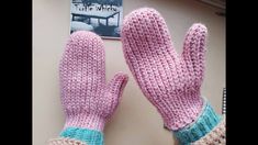 two pink mittens sitting on top of a table