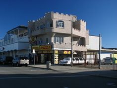 an intersection with cars parked in front of a building