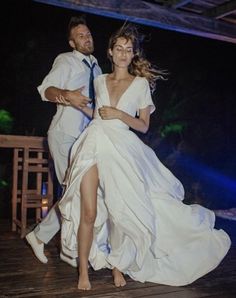 a man and woman are dancing on the dance floor