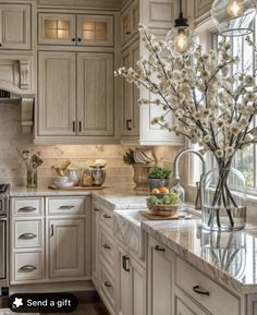 a large kitchen with white cabinets and marble counter tops is featured in this article for the home magazine