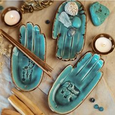 some blue dishes and candles on a table