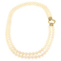 This pearl necklace, with its clasp in 18-karat yellow gold adorned with embedded diamonds, is a classic piece of jewelry reinvented with a touch of modernity. Each pearl, measuring 7 mm in diameter, has been selected for its round shape and smooth, lustrous surface, creating a sequence of elegance and sophistication that adorns the neck with a discreet yet captivating brightness. The heart of this piece, the clasp, is made of precious 18-karat yellow gold, lending the necklace an aura of warmth and value. This element is not just functional but becomes a true focal point thanks to the setting of diamonds chosen for their sparkle and quality. These diamonds add an extra dimension of luxury and brilliance, making the clasp a standout detail that captures light and attention. The combination Classic Akoya Pearl Diamond Necklace For Anniversary, Classic Pearl Diamond Necklace For Formal Occasions, Yellow Gold Single Strand Pearl Necklace For Wedding, Classic Formal Pearl Diamond Necklace, Pearl Necklace For Anniversary, Classic Pearl Necklace With Jewels For Anniversary, Formal Double Strand Pearl Necklace With Pendant, Classic Double Strand Pearl Chain Necklace, Classic White Diamond Necklace With Pearl Chain