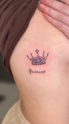 a woman's stomach with a tattoo that says princess on it and a crown