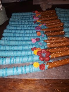 there are many decorated pretzels lined up on the table with blue icing