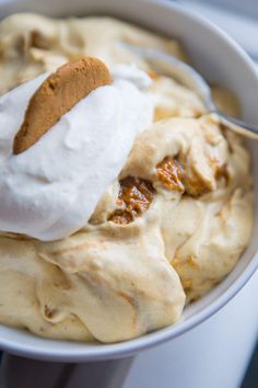 a bowl filled with ice cream and some kind of dessert on top of the bowl