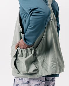 The Takibi Weather Cloth Vest is a fire-resistant utility vest. The vest features adjustable straps with metal buckle closures, a zip front with a chest snap, dual oversized pouch pockets with hook-and-loop secured envelope flaps, dual side loops, oversized back storage pouches, and an additional storage loop at the curved hem. The Takibi Vest is designed to fit loose on the body with the hem hitting below the waist. We recommend taking your normal size for an oversized fit. The model stands 6' Techwear Hiking Vest With Multiple Pockets, Utility Vest With Functional Pockets, Outdoor Techwear Vest With Cargo Pockets, Utility Vest With Functional Pockets For Streetwear, Utility Nylon Vest Outerwear, Utility Wear, Utility Vest, Snow Peak, Storage Pouch