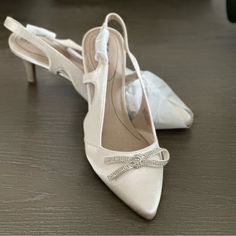 Bought For Wedding But Never Wore. Color: Bone Adjustable Sling Back “Soft System” For Comfort. Satin Upper 2.75” Covered Heel Elegant Ankle Strap Wedding Shoes For Bridal Shower, Elegant Champagne Wedding Shoes With Heel Strap, Elegant High Heel Bridal Accessories, Elegant 4-inch Heels For Bridal Shower, Elegant Slingback Pumps With Ankle Strap For Weddings, Elegant Closed Toe Slingback Pumps For Wedding, Elegant Ankle Strap Slingback Pumps For Wedding, Elegant Wedding Slingback Pumps With Ankle Strap, Elegant Wedding Slingback Pumps With Closed Toe