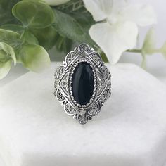 925 Sterling Silver Genuine Natural Black Onyx Gemstone Handmade Artisan Crafted Filigree Statement Ring  Material: 925 Solid Sterling Silver, 925 Stamped Genuine Black Onyx Gemstone Dimensions: 14 mm x 7 mm, Oval, Cabochon, Approximate Total Carat Weight: 2.7 Ring Face Length: 1.10 inches   Ring Face width: 0.45 inches  Finishing: Oxidized & Polished This will come in a designer pouch & gift box  Free Domestic Shipping Our fine silver jewelry is made in our exclusive artisan workshops in Turkey Onyx Silver Ring, Fine Silver Jewelry, Wedding Anniversary Rings, Onyx Gemstone, Mens Silver Rings, Handmade Rings, Ring Women, Blue Topaz Ring, Oval Cabochon