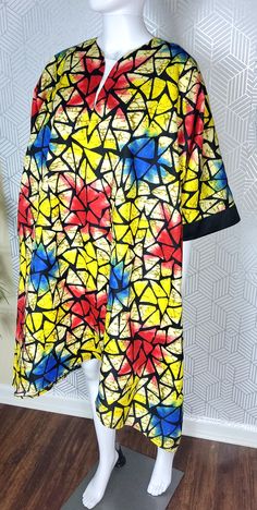 This beautifully crafted kaftan dress features a colorful colorblock pattern, with asymmetrical Ruffles sleeves and a unique button accent. The dress has a round neckline and is closed with a button, making it perfect for a variety of occasions such as travel, weddings, parties, casual or formal events, and workwear.  The dress is made from high-quality polyester material, which is machine washable for easy care. It's available in size M, and L and is handmade, perfect for women who appreciate u Multicolor Printed Dress With Asymmetrical Hem, Multicolor Asymmetrical Dress With Print, Oversized Multicolor Patchwork Dress, Casual Multicolor Dresses With Kimono Sleeves, Casual Multicolor Tunic Kaftan, Multicolor Printed Short Sleeve Tunic, Casual Multicolor Kaftan With Vibrant Print, Multicolor Printed Short Sleeve Kaftan, Casual Multicolor Short Sleeve Tunic