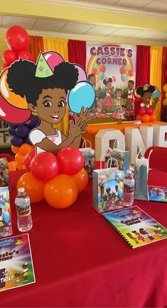 the table is set up with balloons and books for children's birthdays to read