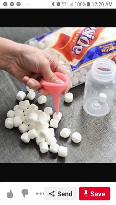 someone is pouring marshmallows into a container