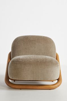 an upholstered chair with wooden legs and seat cushion, on a white background